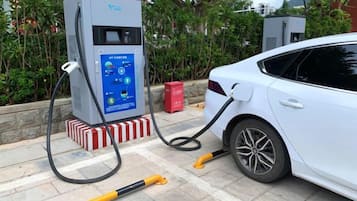 A car charging at a public electric vehicle charging station.