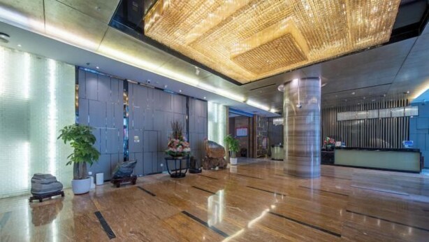 A spacious lobby with a polished marble floor, a large chandelier, and a reception desk. - Ruiyang Crown Hotel (Yining City)