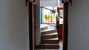 A staircase leading to a balcony with potted plants. - Villa Pepita Real (Villa de Leyva)