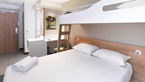 A bunk bed with a wooden headboard, a white bathroom with a sink and mirror, and a painting on the wall. - SUN1 Milnerton (Cape Town)