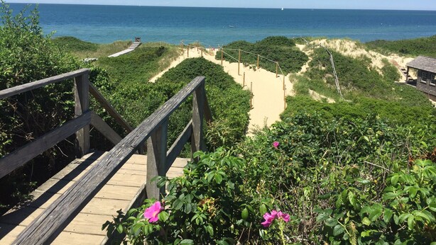 A wooden boardwalk leading to a beach with sand dunes and a view of the ocean. - Charming Post and Beam Cottage! Walk to the beach, Tennis, Bike Path, & Shuttle (Nantucket)