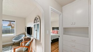 A room with a TV, a desk, a chair, a wardrobe, and a bed. - This is Boise's Gem! (Boise)