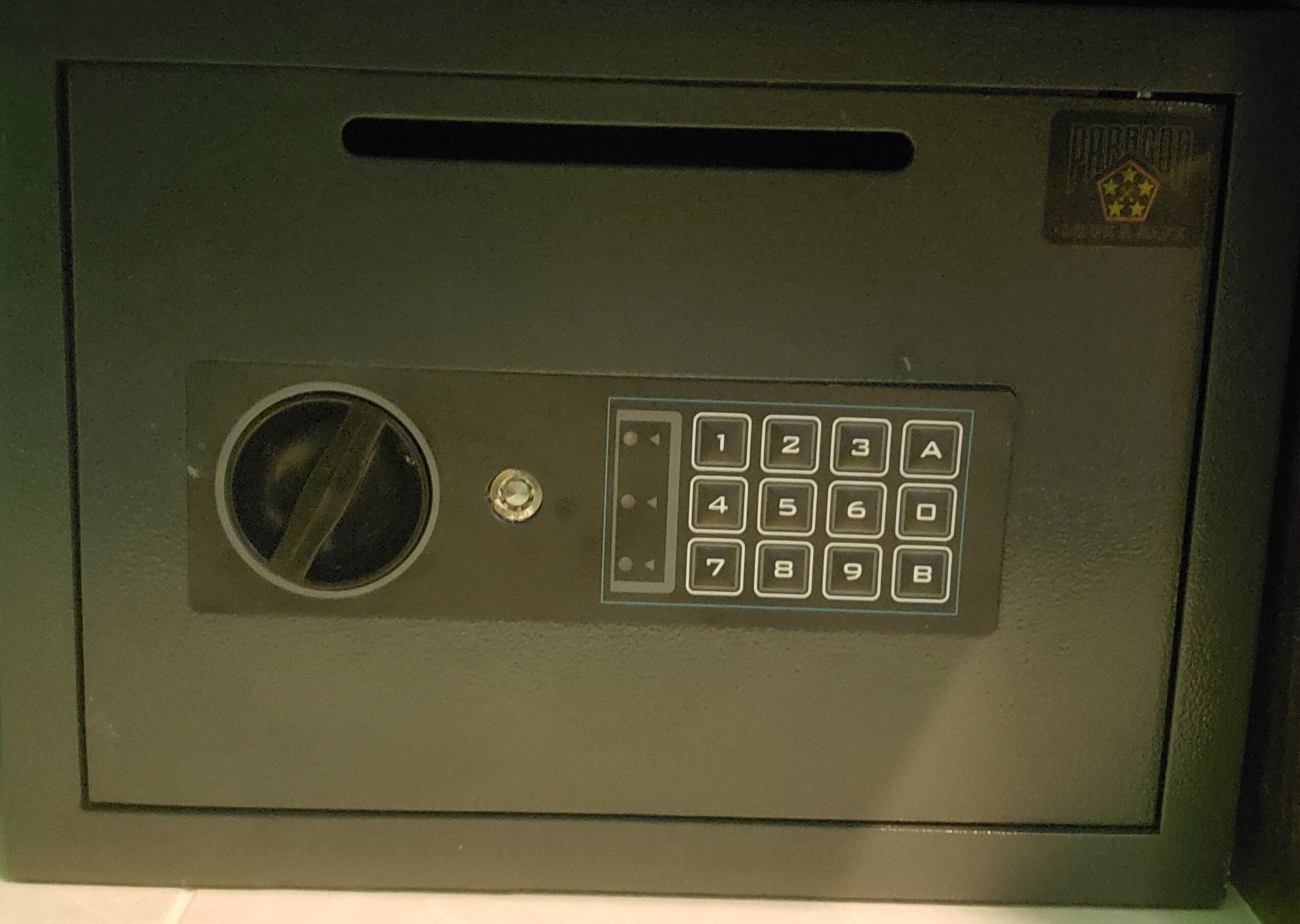A keypad lock with a circular vent and a small logo on the top right.