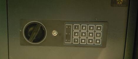 A keypad lock with a circular vent and a small logo on the top right.