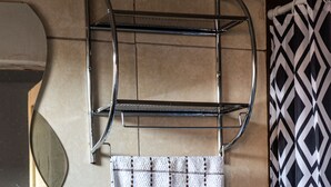 A bathroom with a toilet, a sink, a towel rack, and a shower curtain. - Studio for rent in Cusco city center! (Cusco)