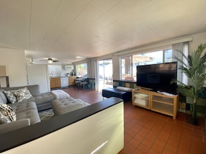 Relax in this stylish living area with a sofa, flat-screen TV, and dining table.