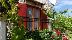 A stone house with a red door and a satellite dish. - Countryside Family Villa with Private Pool (Donje Selo)