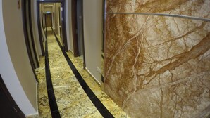 A marble-floored hallway with doors on both sides leading to rooms. - Nova Hotel Miri (Miri)