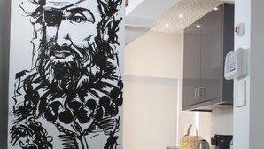 Una cocina moderna con armarios oscuros, una encimera blanca y una cafetera.