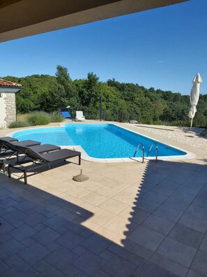 A heated pool, pool loungers