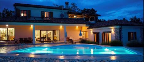 A heated pool, sun loungers