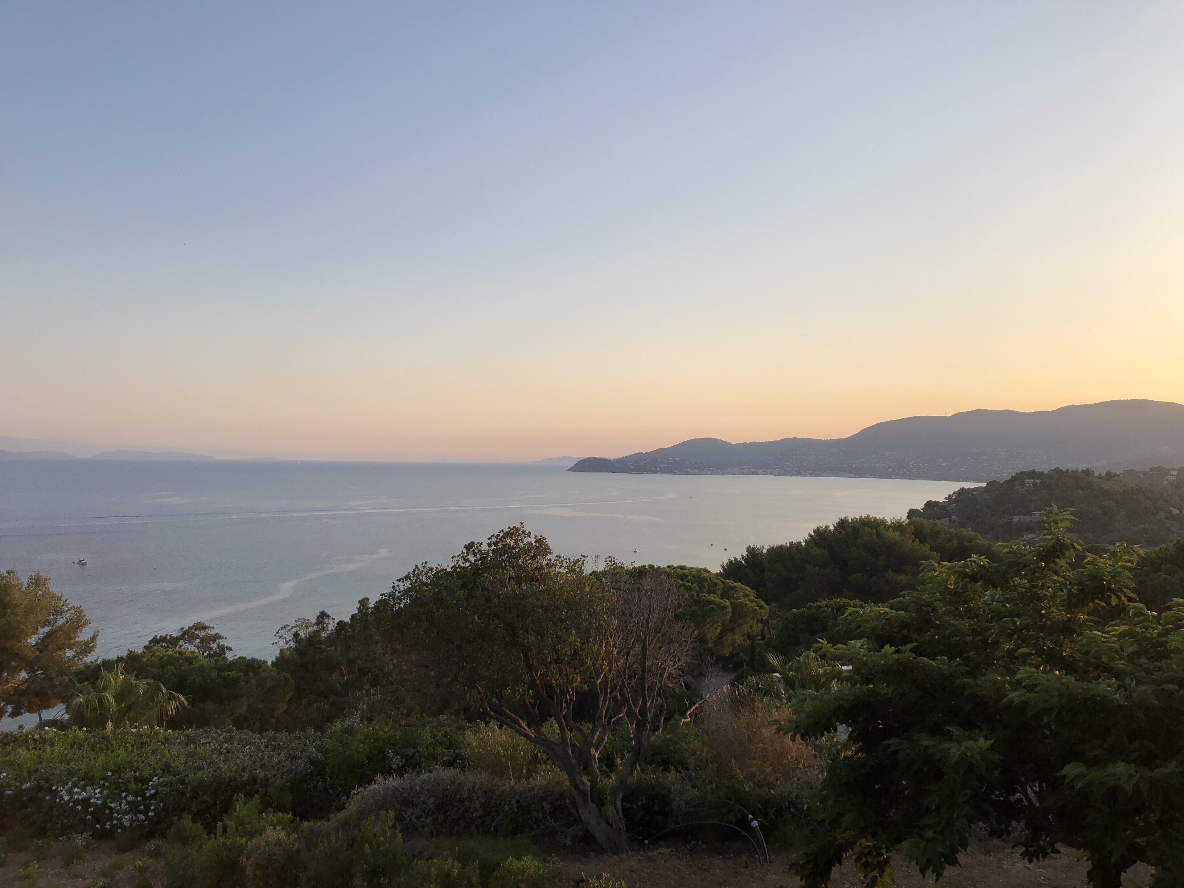 A coastal landscape with a view of the sea and distant hills.