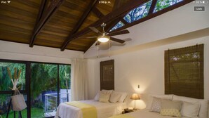 A hotel room with two beds, a ceiling fan, and a view of the outdoors. - MODERN AND MAGICAL VILLA WALKING DISTANCE FROM THE BEACH!  (Guanacaste)