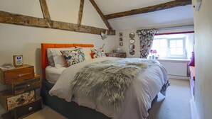 A bedroom with a bed, wooden beams, a window, and a dresser. - 'Oh So Snug' Bijou 1-bedroom cottage, in the heart of Whalley, Clitheroe  (Whalley)