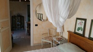 A bedroom with a canopy bed, a small table with a magazine, and a chair. - PEACE AND PRIVACY AT HOME "Il CORBEZZOLO" (Poggio Catino)