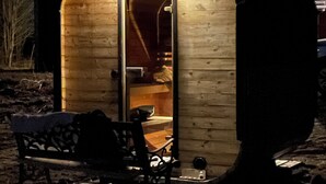 A small, wooden cabin with a single visible room containing a bed and a chair. - Cottage with access to silence, only nature's own sounds. (Åmotsbruk)