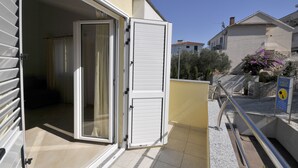 Ein Wohngebäude mit einer Schiebetür, die auf einen Balkon führt.