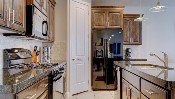 A modern kitchen with granite countertops, stainless steel appliances, and wooden cabinets. -  St George, near Zion 2 king beds, 2 pools/hot tubs, fish pond  (Washington)