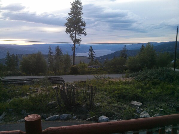 A scenic overlook with a view of distant mountains and a body of water.