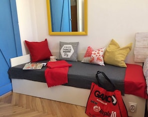 Relax in a cozy seating area with a plush bench and comfortable cushions.