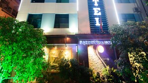 A hotel with a prominent vertical sign reading "BANGKOK HOTEL" and a staircase leading to the entrance.