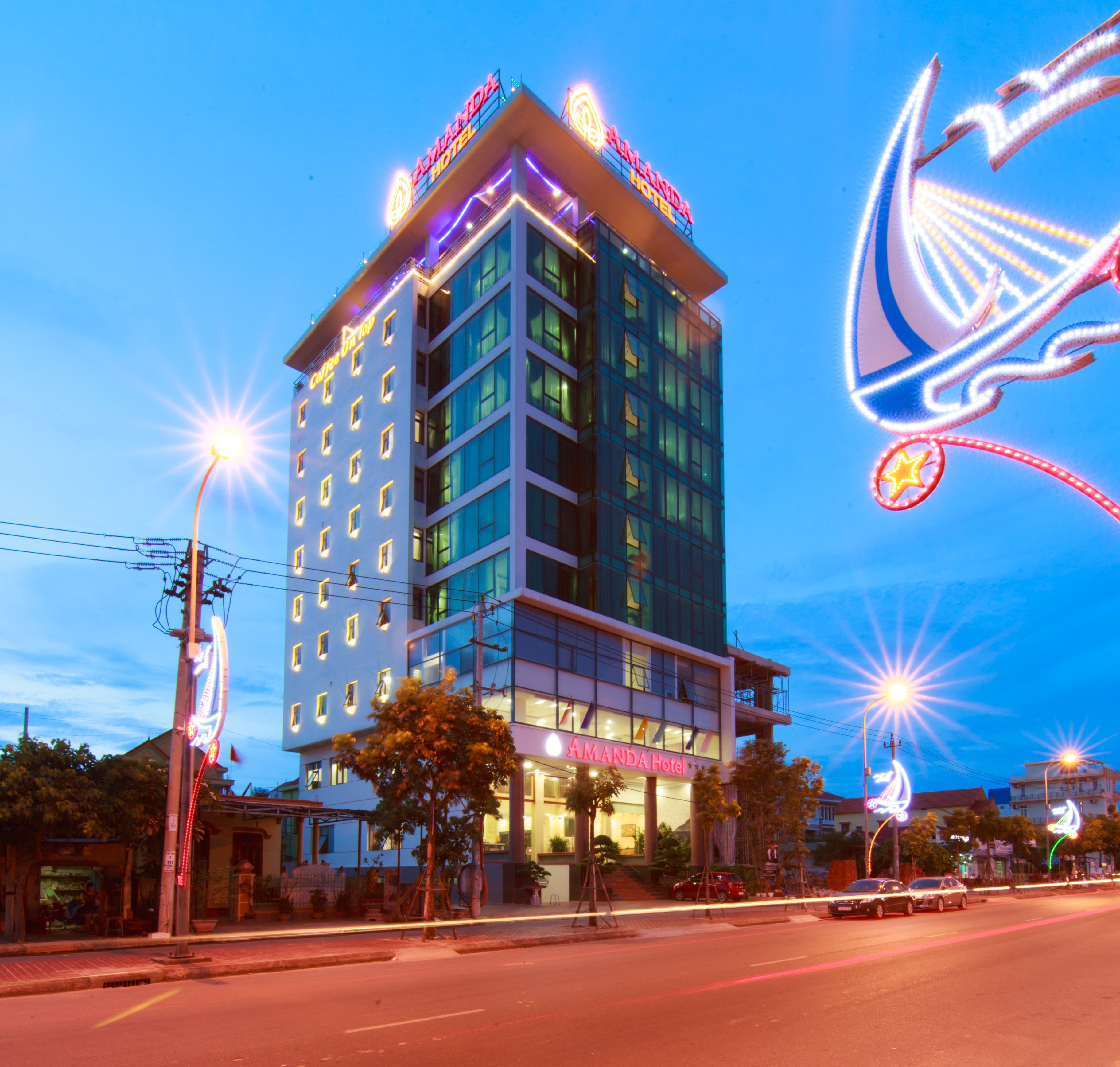 A multi-story hotel with a prominent sign at the top.