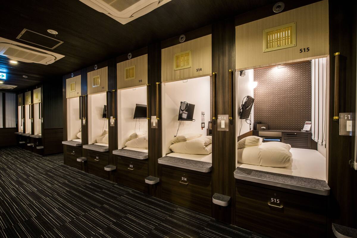 A row of private rooms with individual beds, each marked with a number.