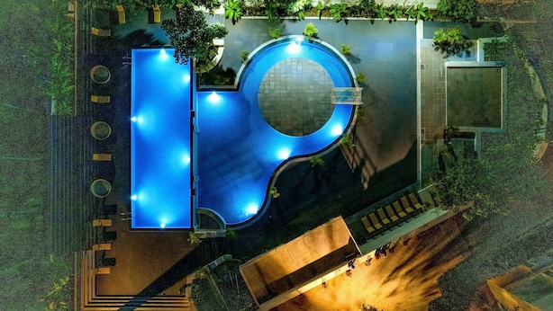 An aerial view of a swimming pool with a circular center and surrounding steps. - Camel Valley Resort & Spa (Igatpuri)