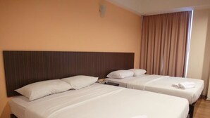 A hotel room with two beds, each with white linens and pillows, a wooden headboard, and a window with curtains. - Li Garden Hotel (Pasir Gudang)