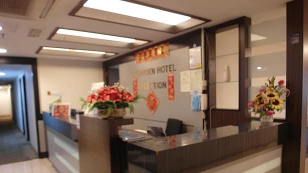 A reception desk with a sign reading "Garden Hotel Reception". - Li Garden Hotel (Pasir Gudang)
