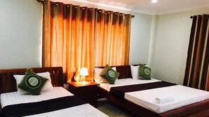 A hotel room with two beds, a nightstand with a lamp, and a large window with curtains. - Blue Diamond Guest House - Hostel (Battambang)