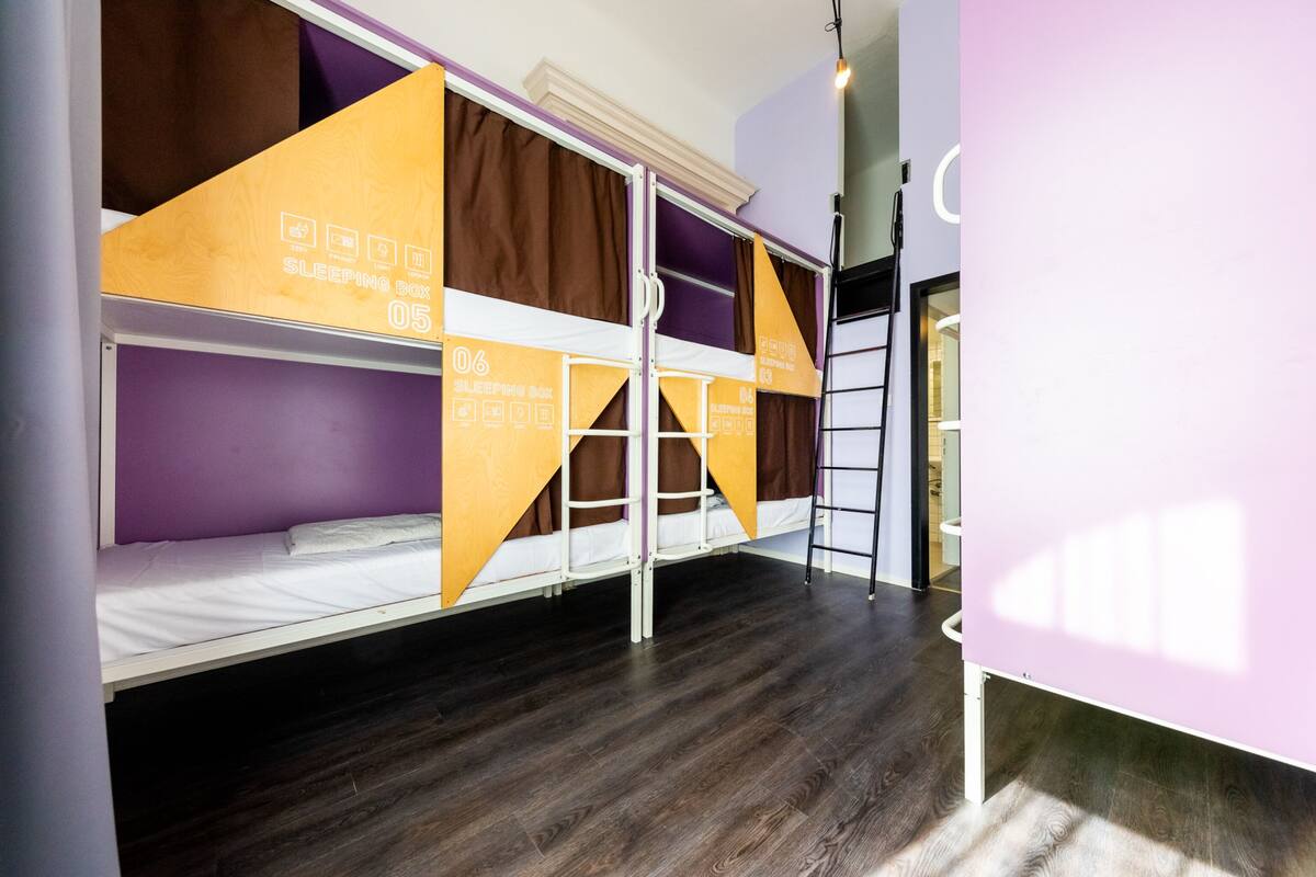 A bunk bed room with a sleeping box labeled '05' and a ladder.