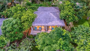 A thatched-roof house surrounded by dense greenery, with a visible porch area and a small water feature. - Lahana Resort Phu Quoc & Spa (Phu Quoc)