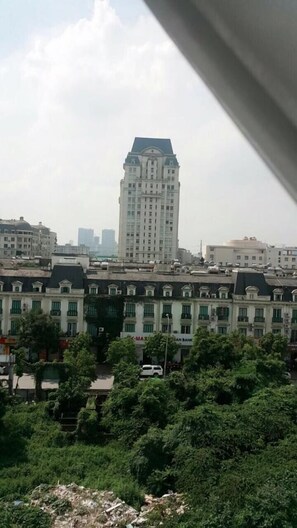A view of a cityscape with a prominent bank building and surrounding residential buildings. - K Business 3 Hotel (Formerly Mai Hotel) (Hanoi)