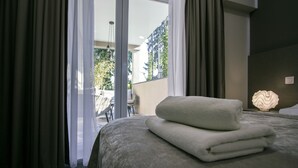 A hotel room with a bed, a nightstand, and a view of the outdoors. - Hotel Sundial (Zagreb)