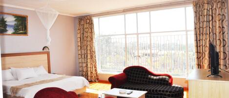 Habitación ejecutiva | Ropa de cama de alta calidad y minibar