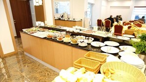 A buffet setup with various food items and baskets. - Adana Omur Otel (Adana)