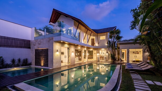 A modern house with a swimming pool, a covered patio, and a well-maintained garden.