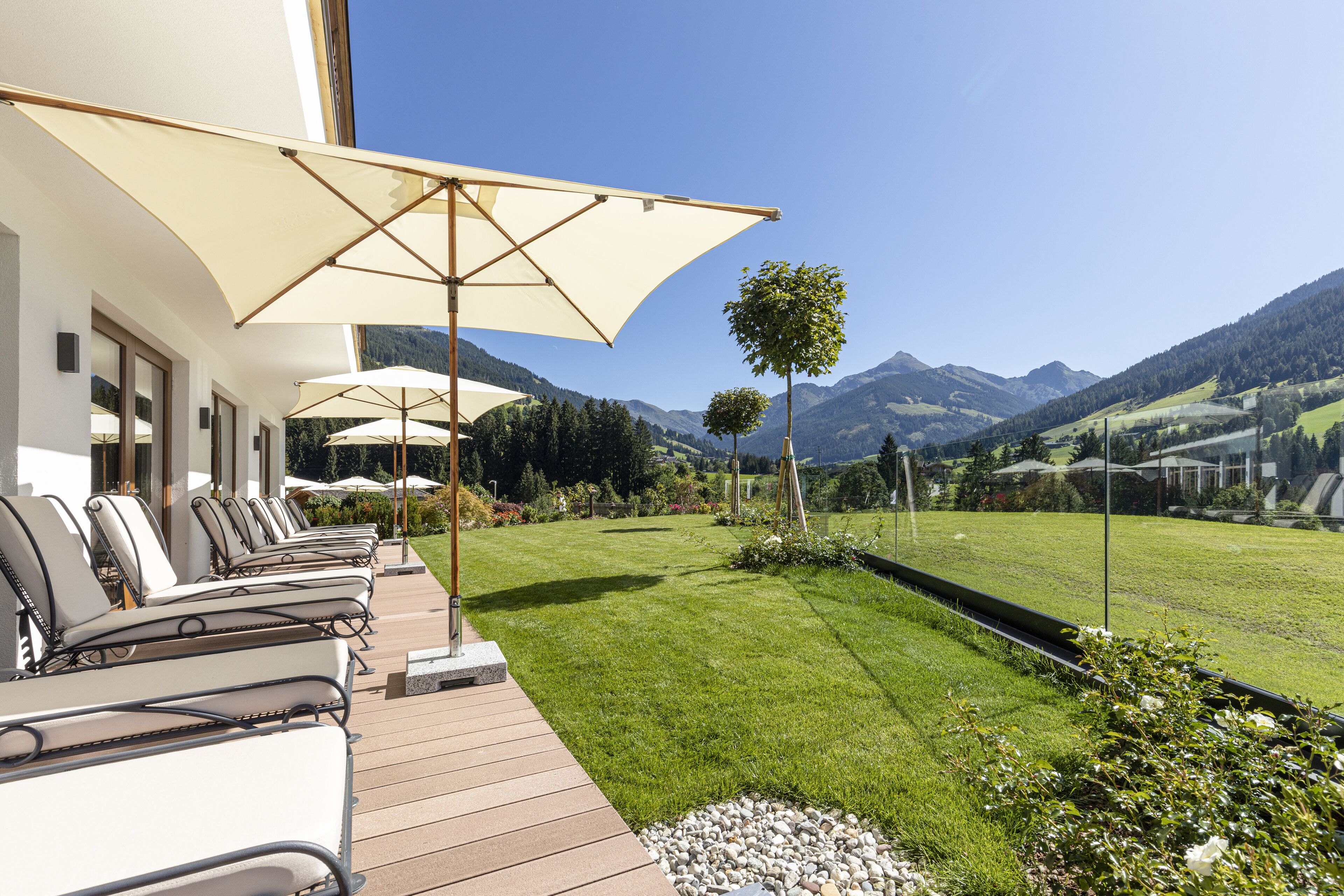 A terrace with outdoor seating and a view of mountains.