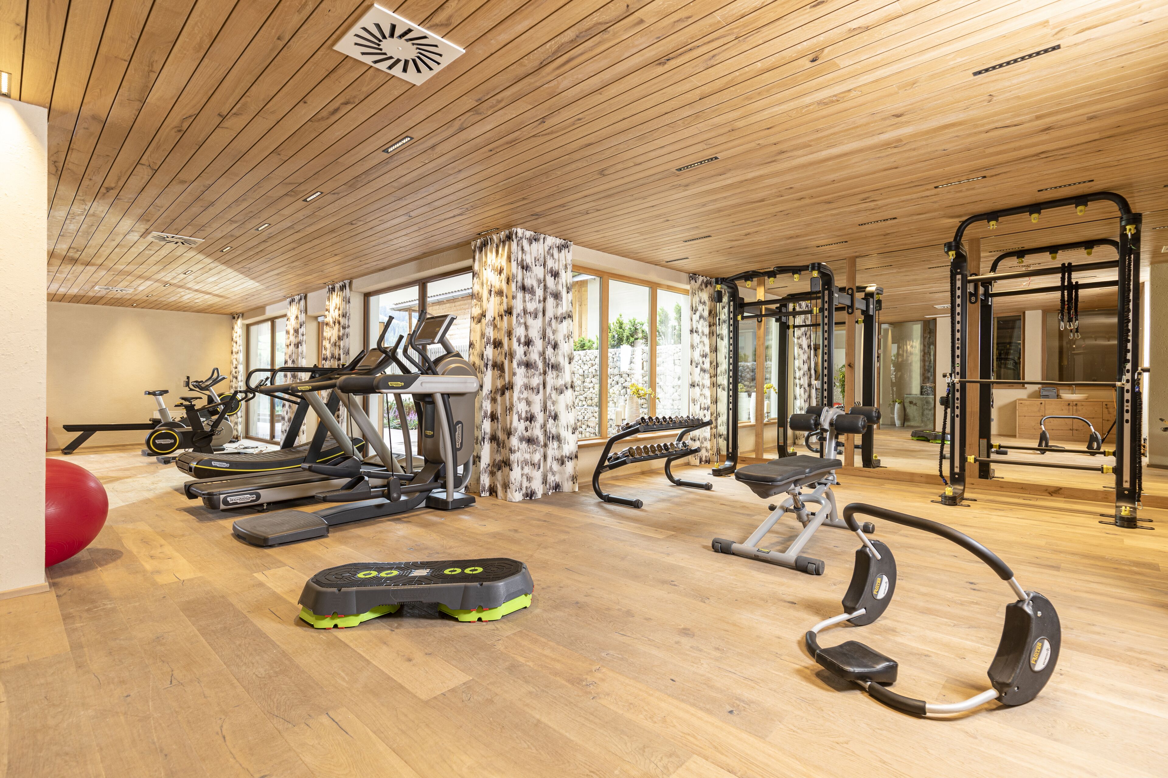 A gym with treadmills, ellipticals, and weight machines.
