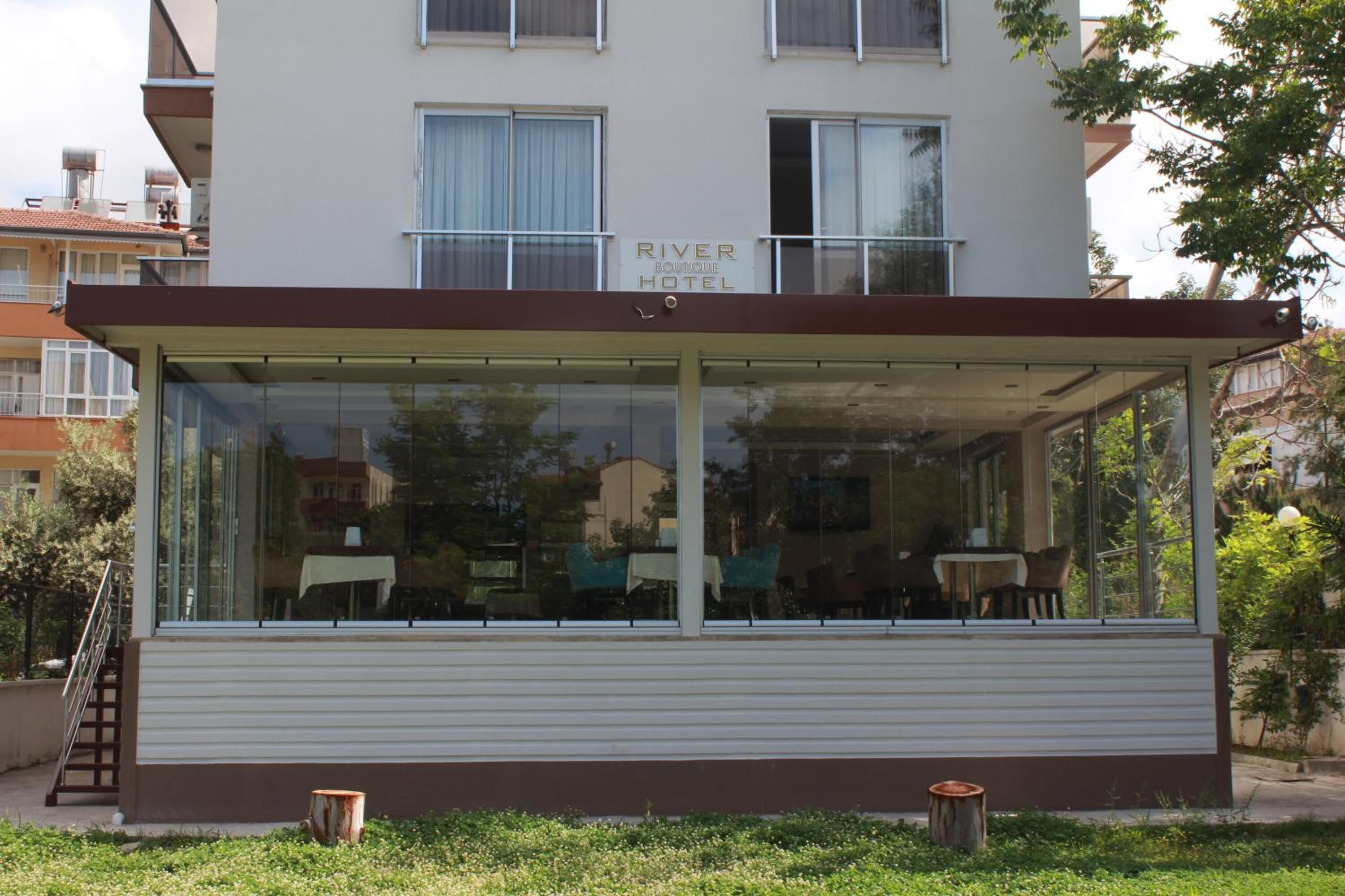 A River Boutique Hotel with a covered outdoor seating area.