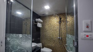 A modern bathroom with a glass shower enclosure, a toilet, and a sink. - Nam Long Hotel Ha Noi (Hanoi)