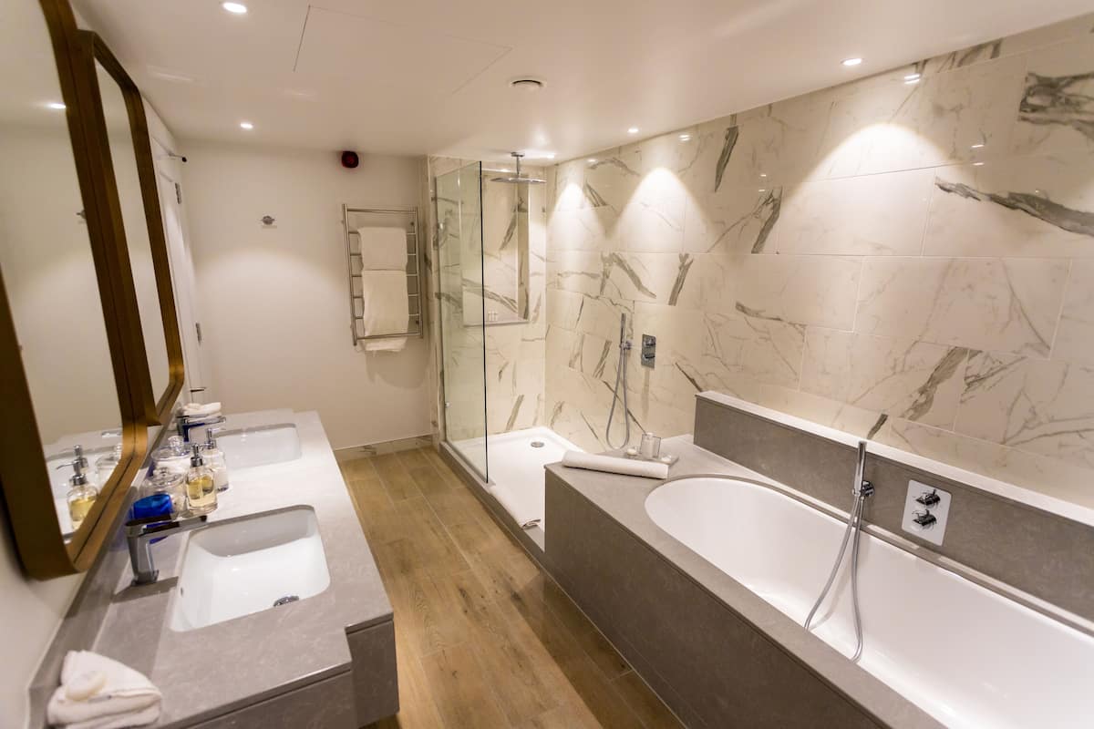 deluxe suite, marina view | bathroom | designer toiletries, hair dryer, bathrobes, slippers