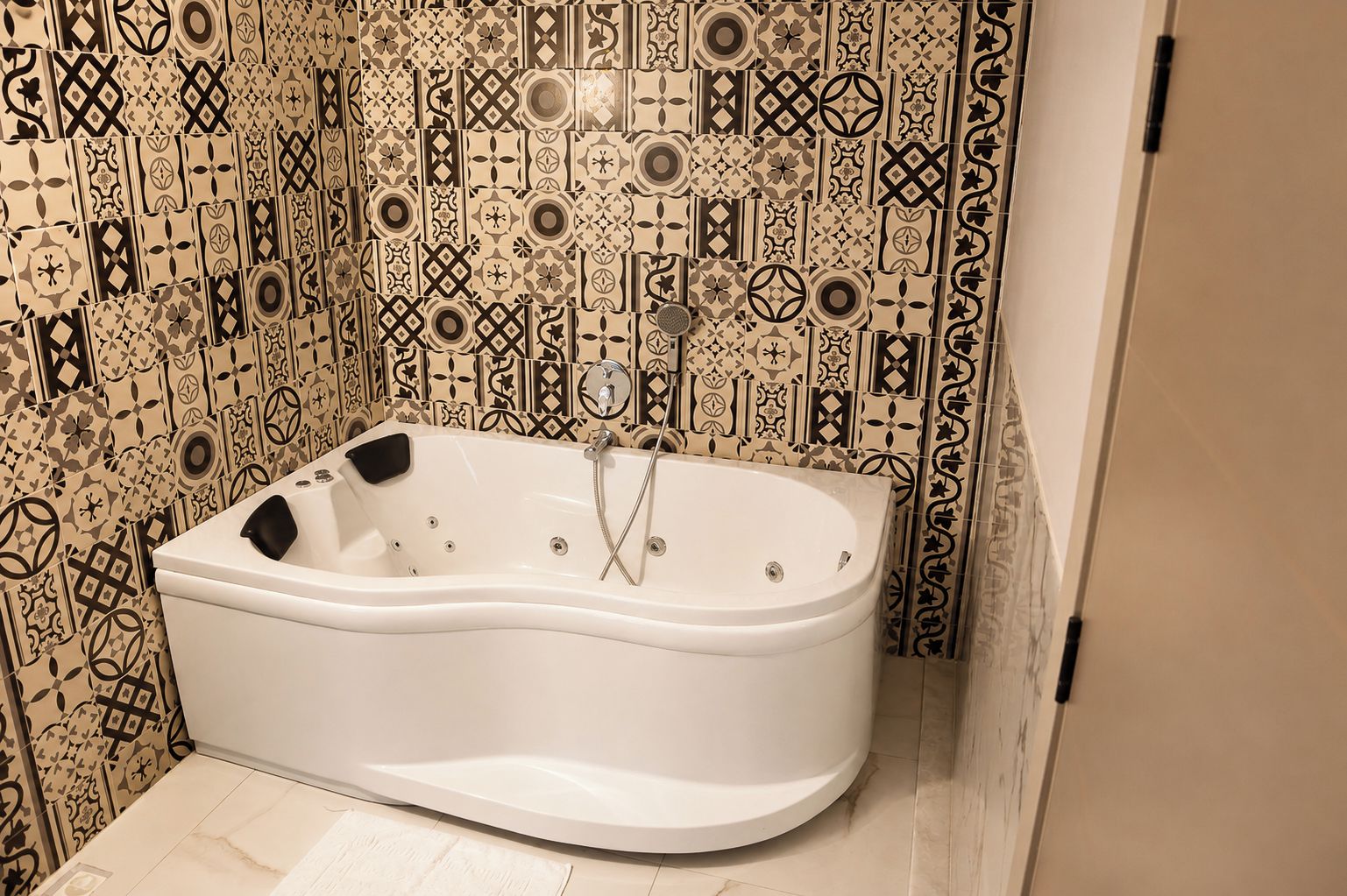 A modern bathroom with a freestanding bathtub, a shower, and a tiled wall with intricate patterns.