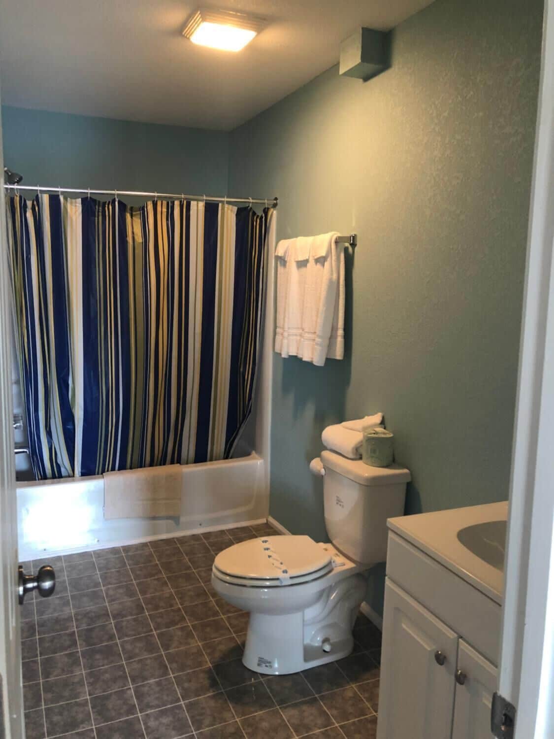 A bathroom with a bathtub, toilet, and sink.