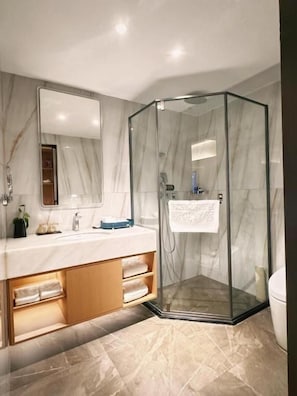 A modern bathroom with a glass-enclosed shower, a marble-tiled floor, and a vanity with a mirror and sink. - Chaozhou Hotel (CHAOZHOU)