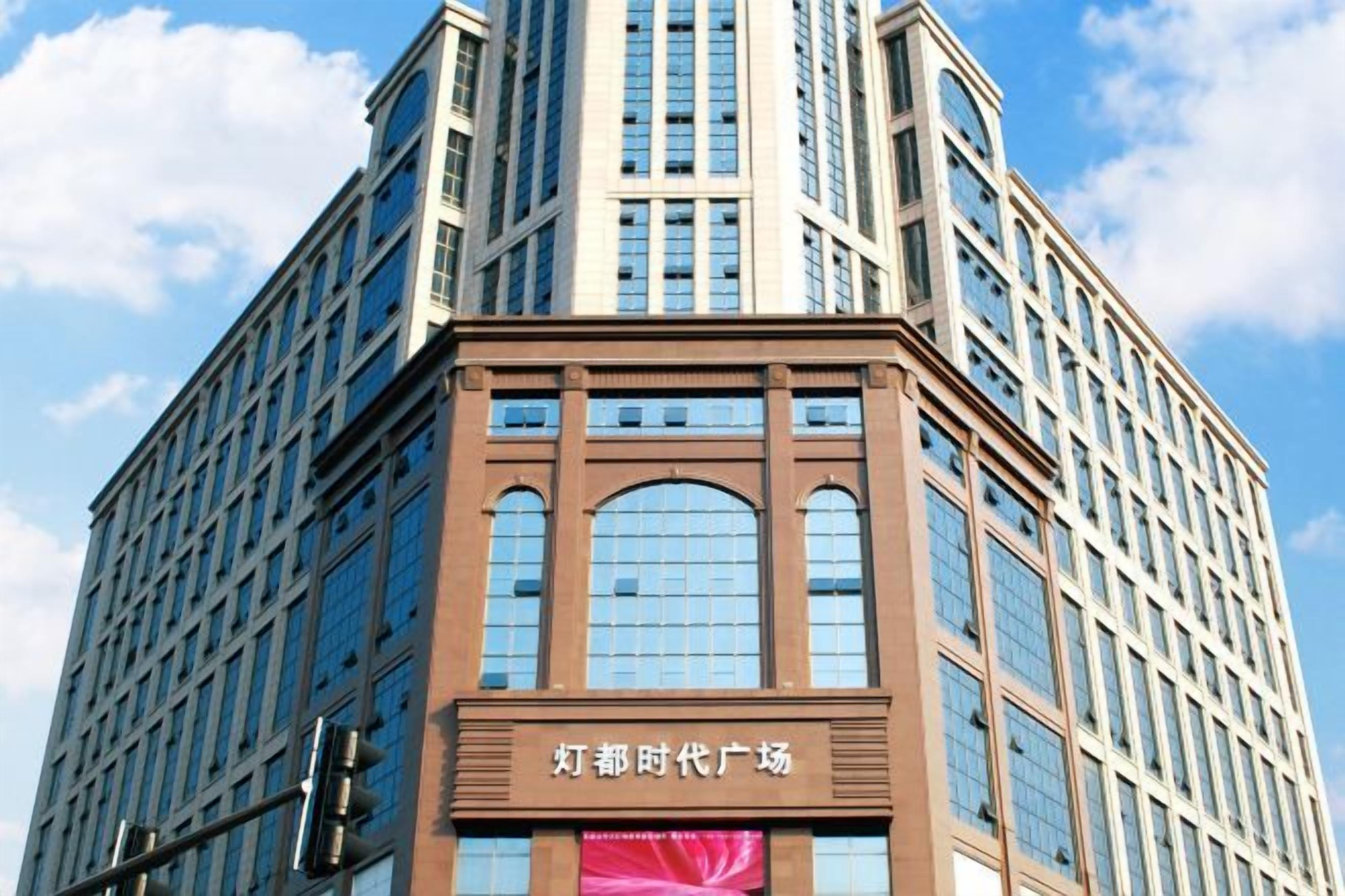A tall building with a prominent entrance and signage.