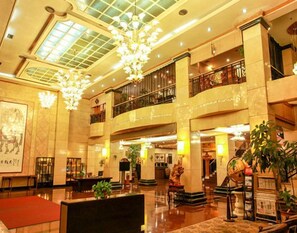 A spacious lobby with a high ceiling, chandeliers, and a grand staircase. - Jinsui Hotel (Hohhot)