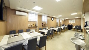 A conference room with tables, chairs, a clock, and a whiteboard. - Hotel Orient Zagreb (Zagreb)