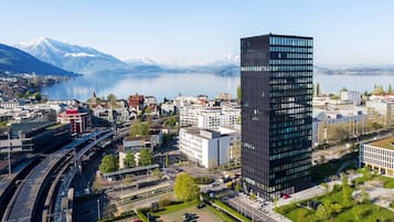 Situated near a body of water, this contemporary building offers stunning views of the surrounding mountains.